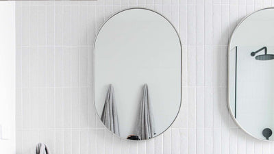 Two oval bathroom mirrors