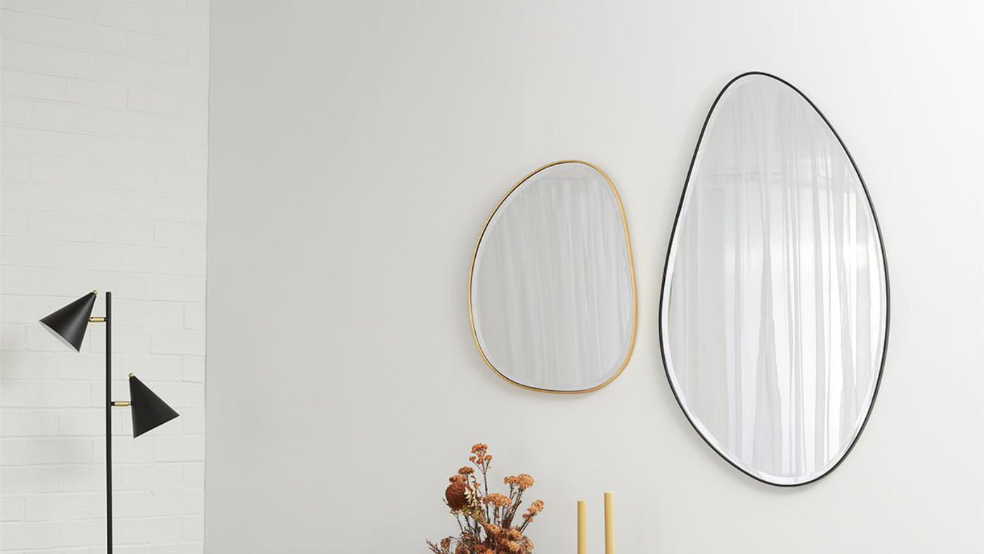 Two round mirrors, one with a gold and one with a black frame.
